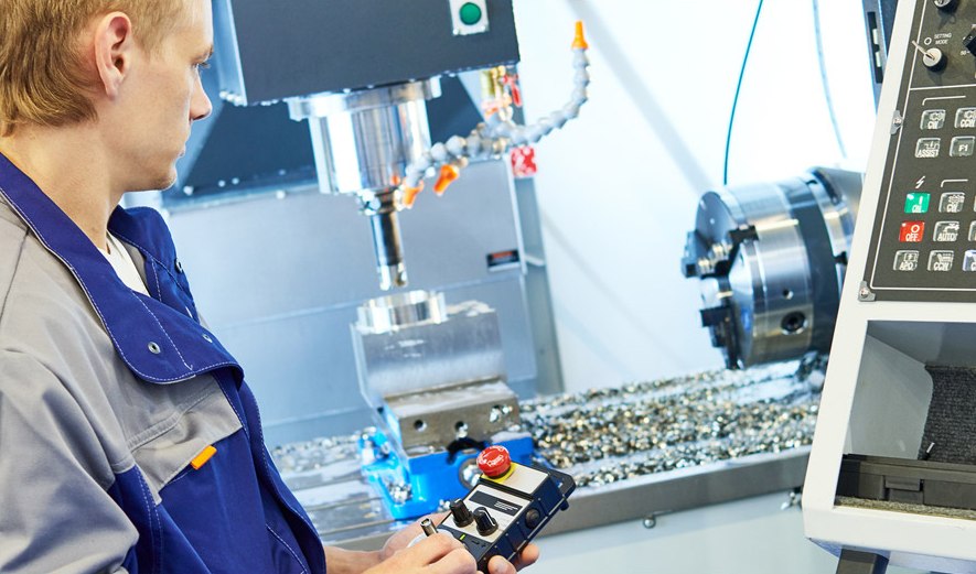 Machinist operating a CNC machining center