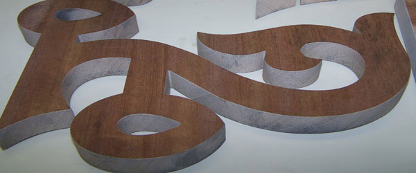 Waterjet-cut wood and metal lettering